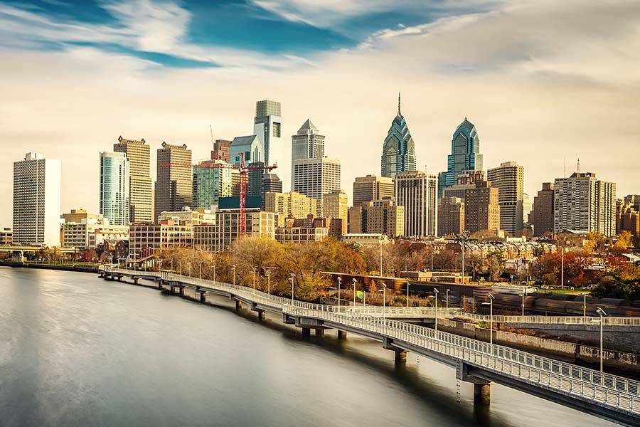 Homepage - View of Philadelphia City Skyline and River Against a Cloudy Blue Sky