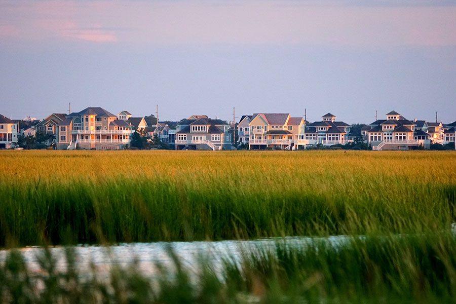 Homepage - View of Waterfront Homes and Tall Green Grass by the Coast in Delaware